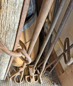 Photo of items for sale at Fly Trap Antiques: selection of branding irons, some hand-wrought, and a single tree (oxen harness)