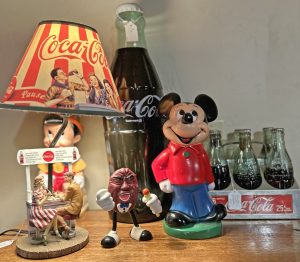 Photo of items for sale at Fly Trap Antiques: A selection of Disney and Coca-Cola memorabilia.