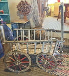 Photo of an item for sale at Fly Trap Antiques: this one is a Primitive Hay Wagon with wooden wheels.